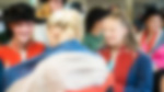 Two girls and a boy aged about fourteen are trying on costumes from Les Miserables. Two are wearing red and blue tunics, and another has a blue, white and red French flag wrapped around themselves. The boy also wears a black hat.